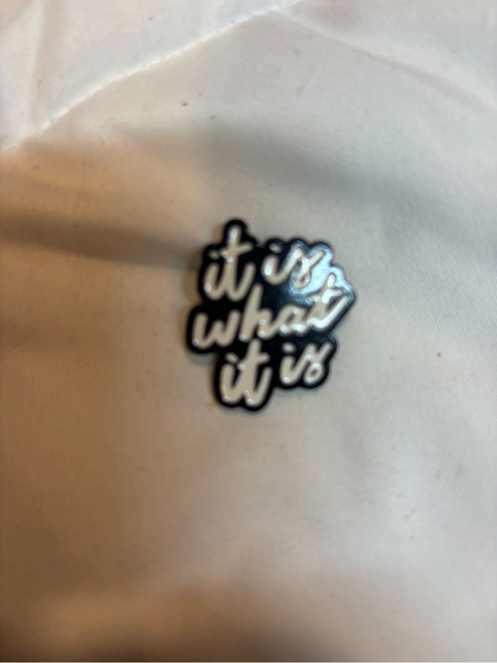 Graphic enamel pin 'It Is What It Is' approximately 1”